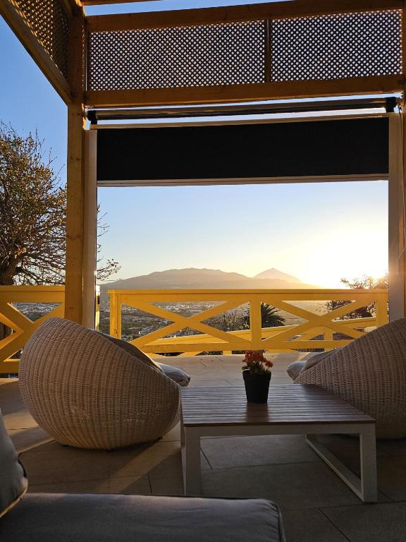a porch with two chairs and a table with a view at Casa de Limon in Cerrogordo