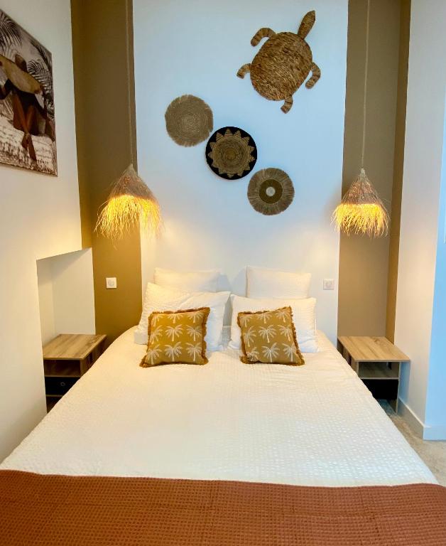 a bedroom with a large white bed with two pillows at Lady Jule Chambres d hôtes & spa in Sainte-Luce-sur-Loire