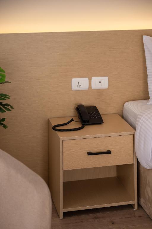Postel nebo postele na pokoji v ubytování Elegance Grand City Hotel