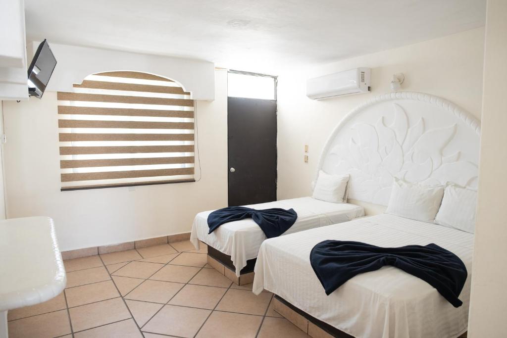 Cama o camas de una habitación en Hotel Vistamar