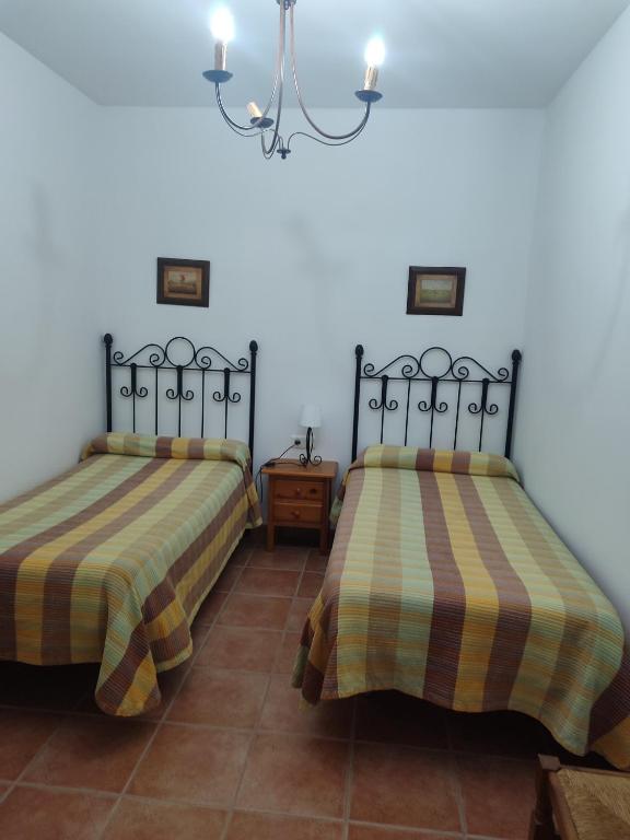 Postel nebo postele na pokoji v ubytování Pensión y apartamentos El Taxi
