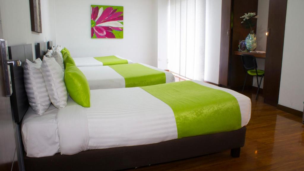 Postel nebo postele na pokoji v ubytování Hotel macao colombia