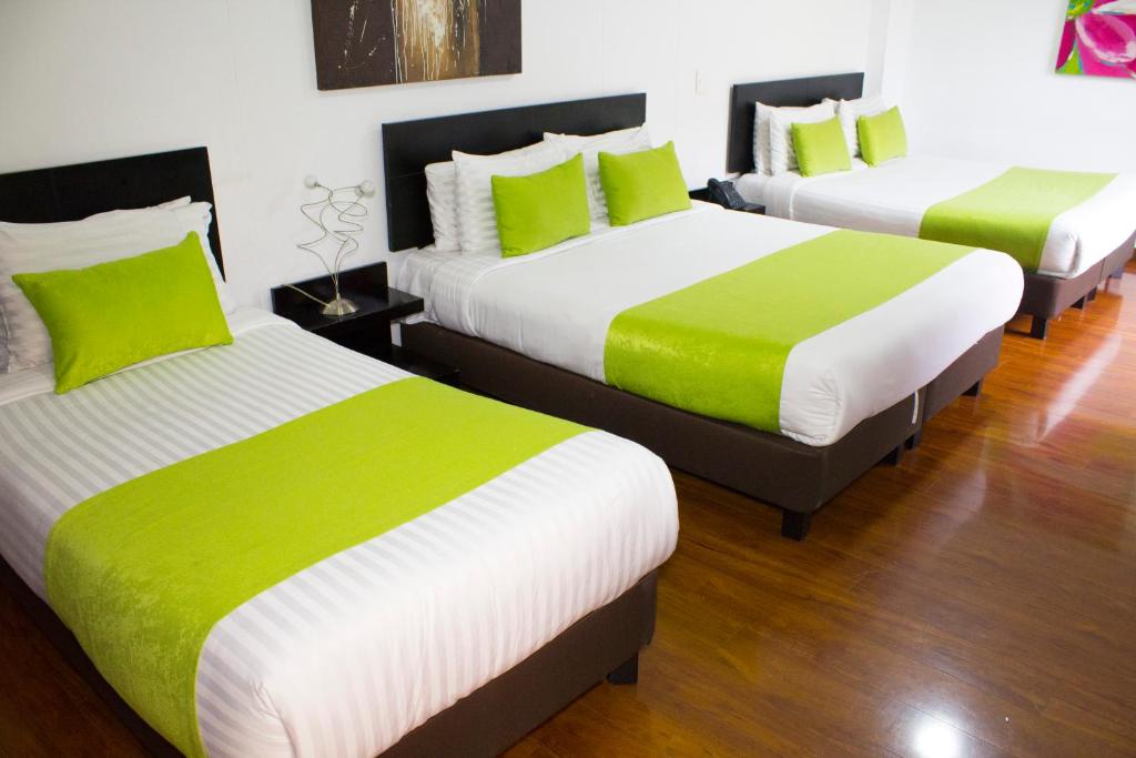 Postel nebo postele na pokoji v ubytování Hotel macao colombia
