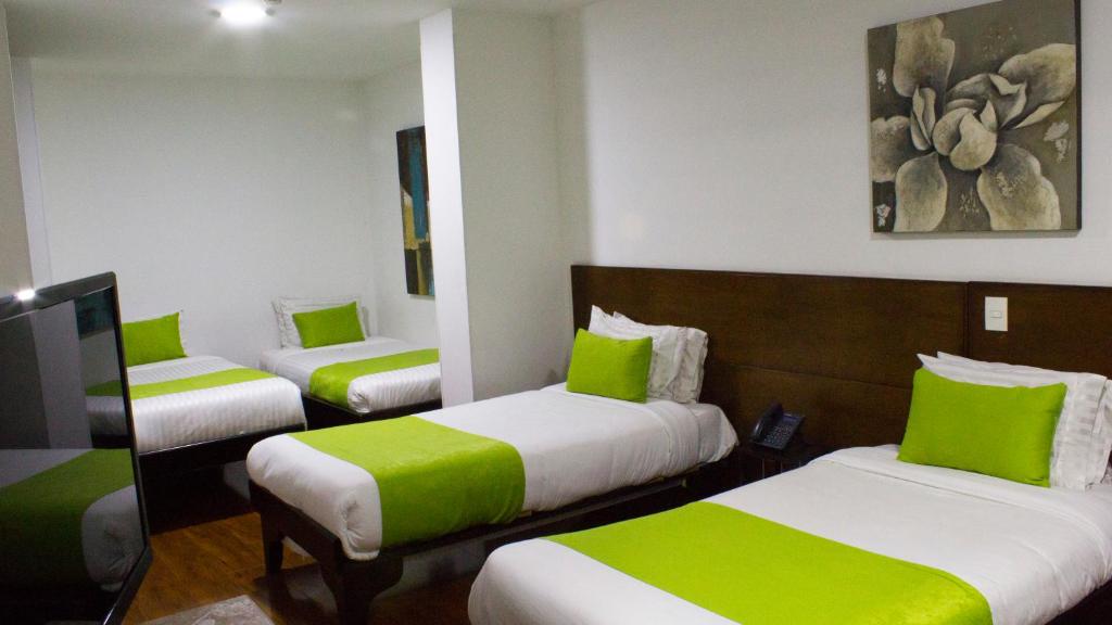 Postel nebo postele na pokoji v ubytování Hotel macao colombia