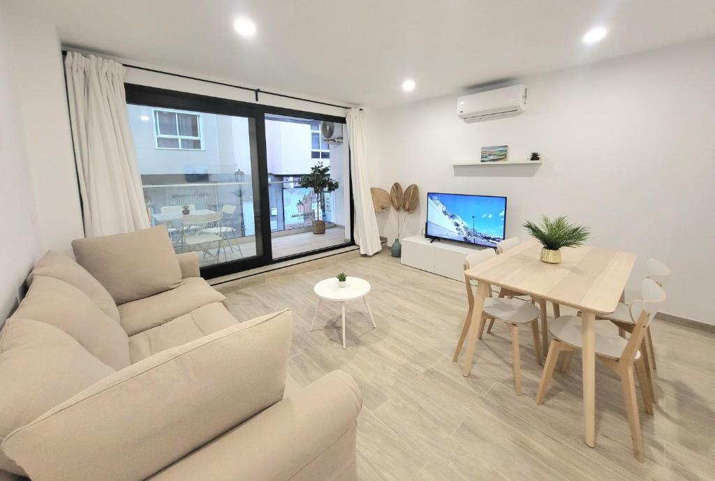 a living room with a couch and a table at Arguineguin Sun Beach in Arguineguín