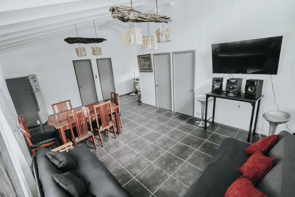 a living room with a couch and a table at Cabañas Altos del Volcán in Villarrica