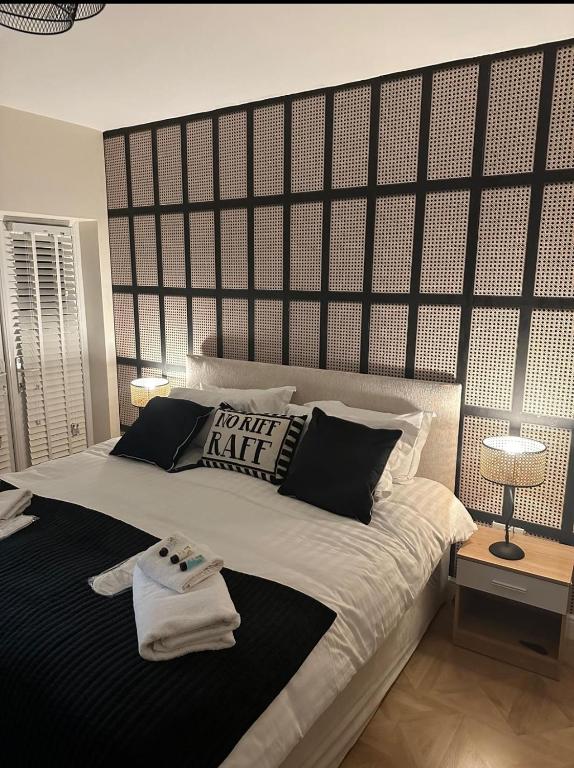 a bedroom with a large bed with a large headboard at The Mayfair Lodge & Family Suite in Hartlepool