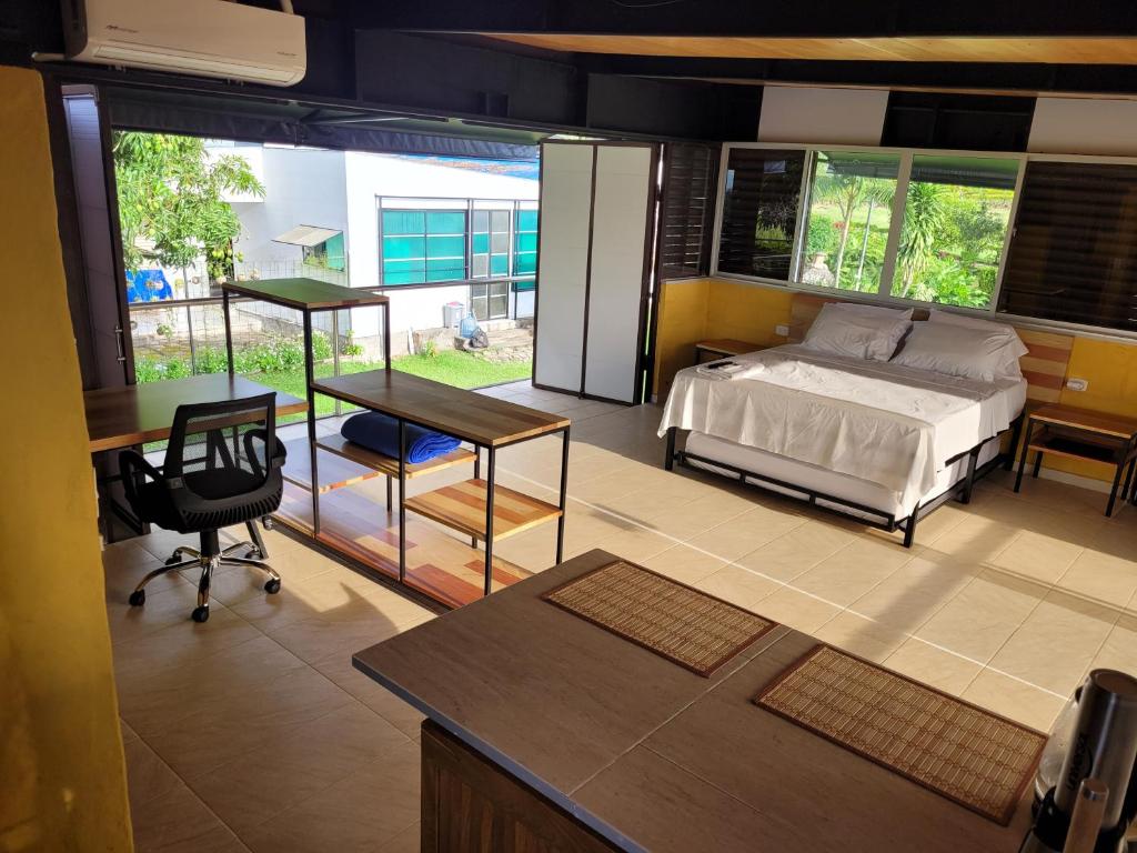 a bedroom with a bed and a desk and a table at Finca Termópilas in Rivera