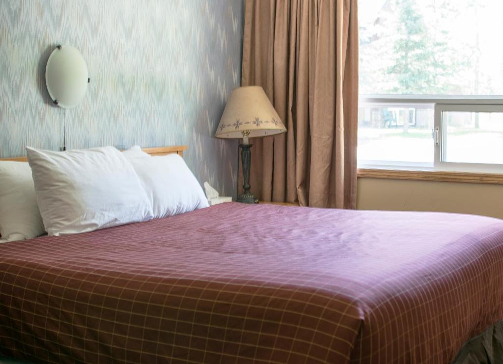 Postel nebo postele na pokoji v ubytování Aspen Village