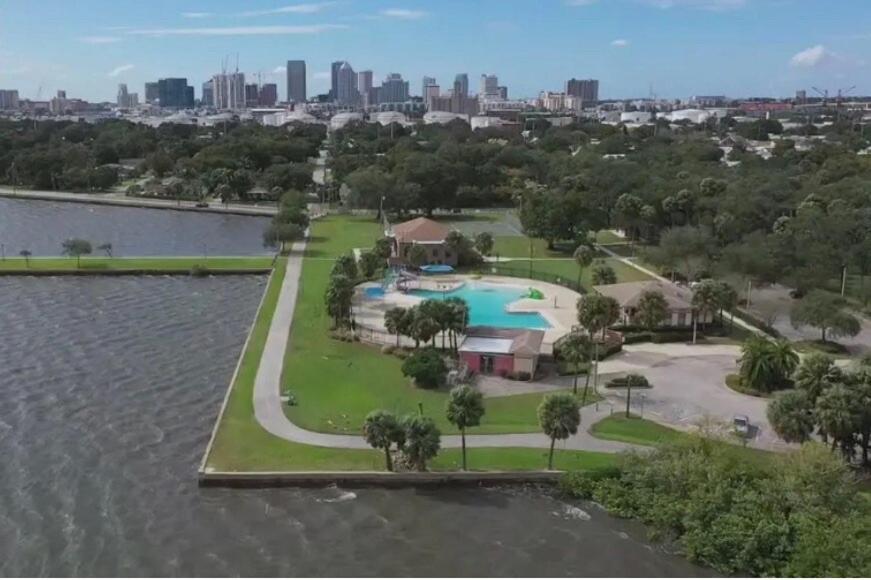 an aerial view of a resort with a pool in the water at Channel Side,Down Town Tampa ,Ybor Palmetto Beach with pickle ball court in Tampa