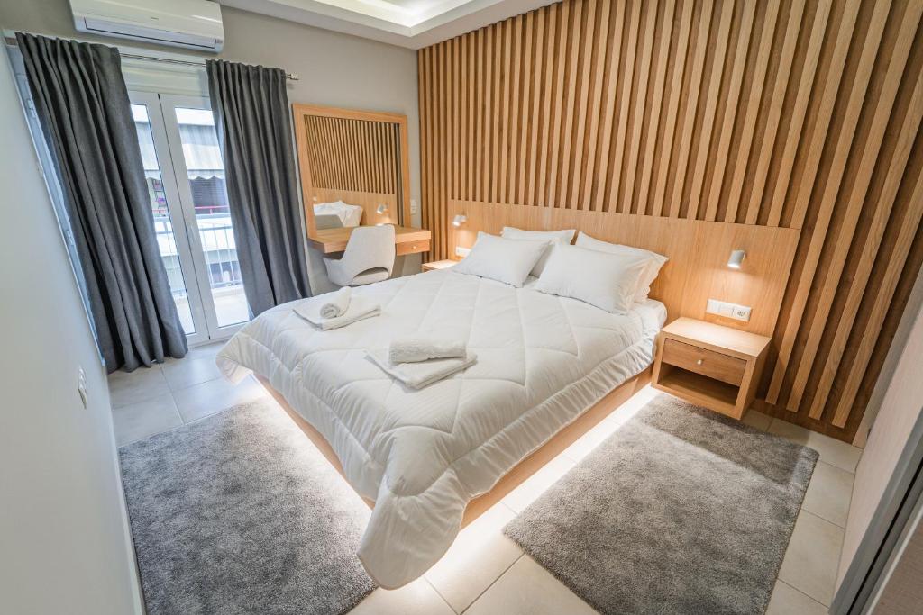 a bedroom with a large white bed in a room at Ioannina Center Apartment in Ioannina