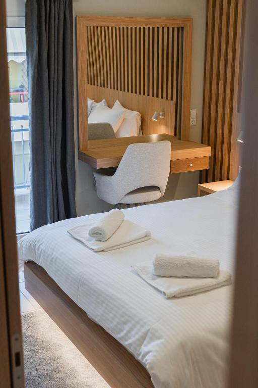 a bedroom with a bed with a desk and a chair at Ioannina Center Apartment in Ioannina