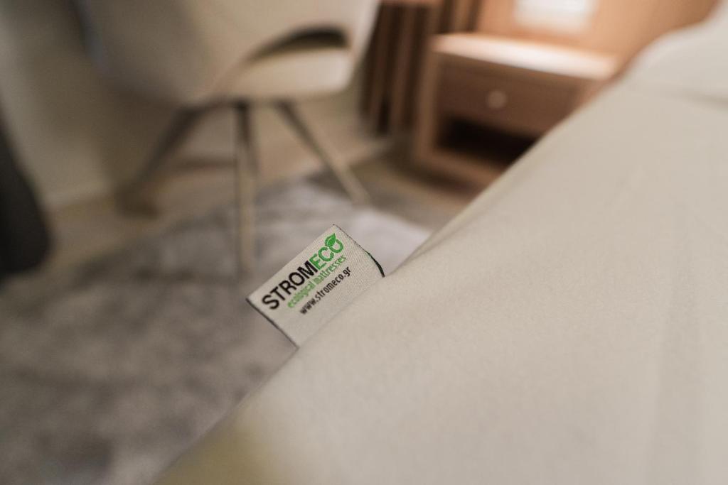 a hotel room with a sign on a bed at Ioannina Center Apartment in Ioannina