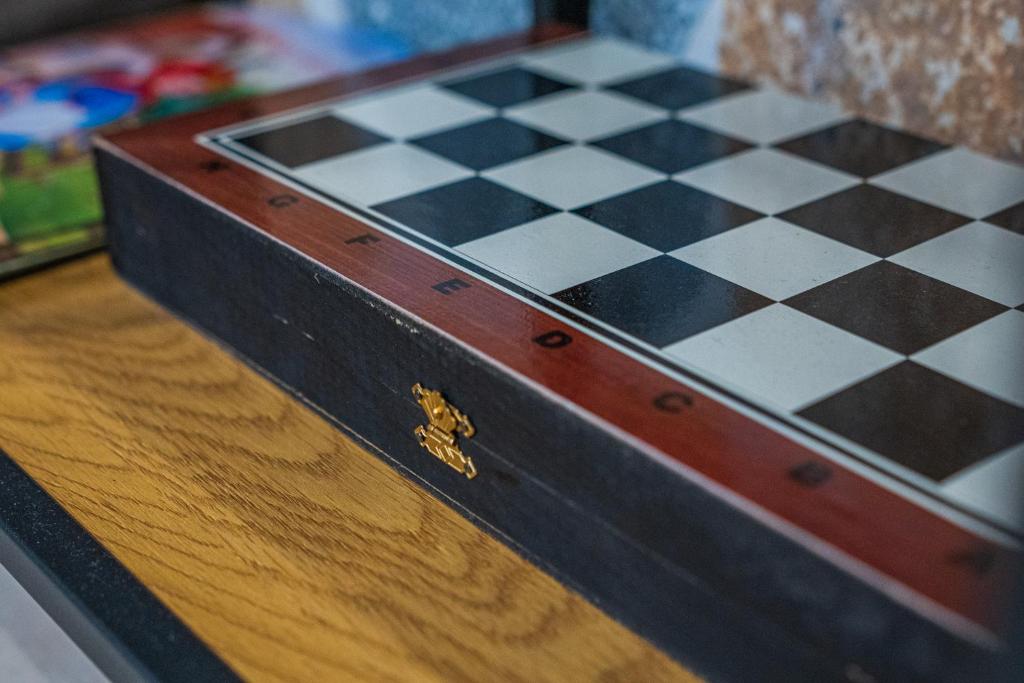 a chess board on top of a wooden table at Ioannina Center Apartment in Ioannina