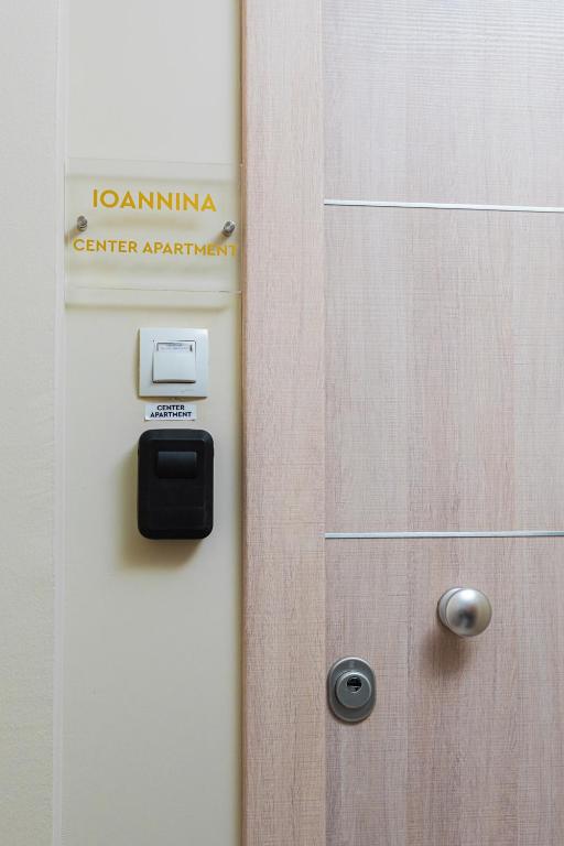 a door with a sign that reads ioannina germanartifacts at Ioannina Center Apartment in Ioannina