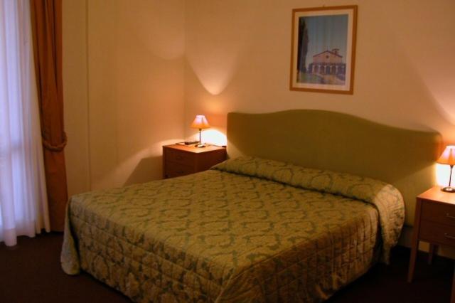 Postel nebo postele na pokoji v ubytování Hotel Barberino