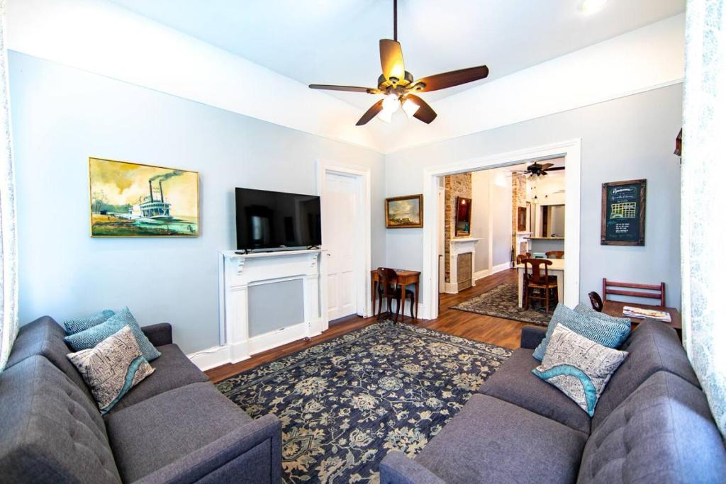 a living room with a couch and a ceiling fan at St Ann Creole Victorian - 5 bed-5 bath in New Orleans