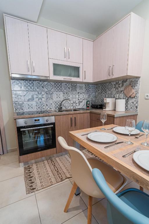 a kitchen with a wooden table with two chairs at Ioannina Center Apartment in Ioannina