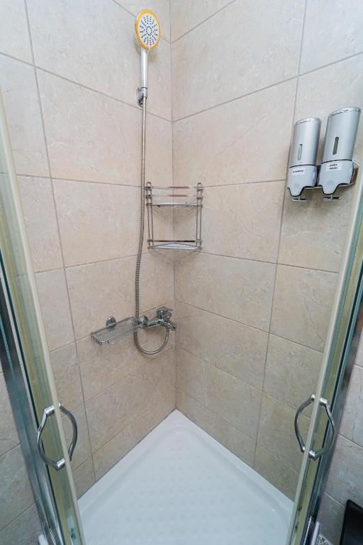 a shower stall with a shower head and a shower at Ioannina Center Apartment in Ioannina