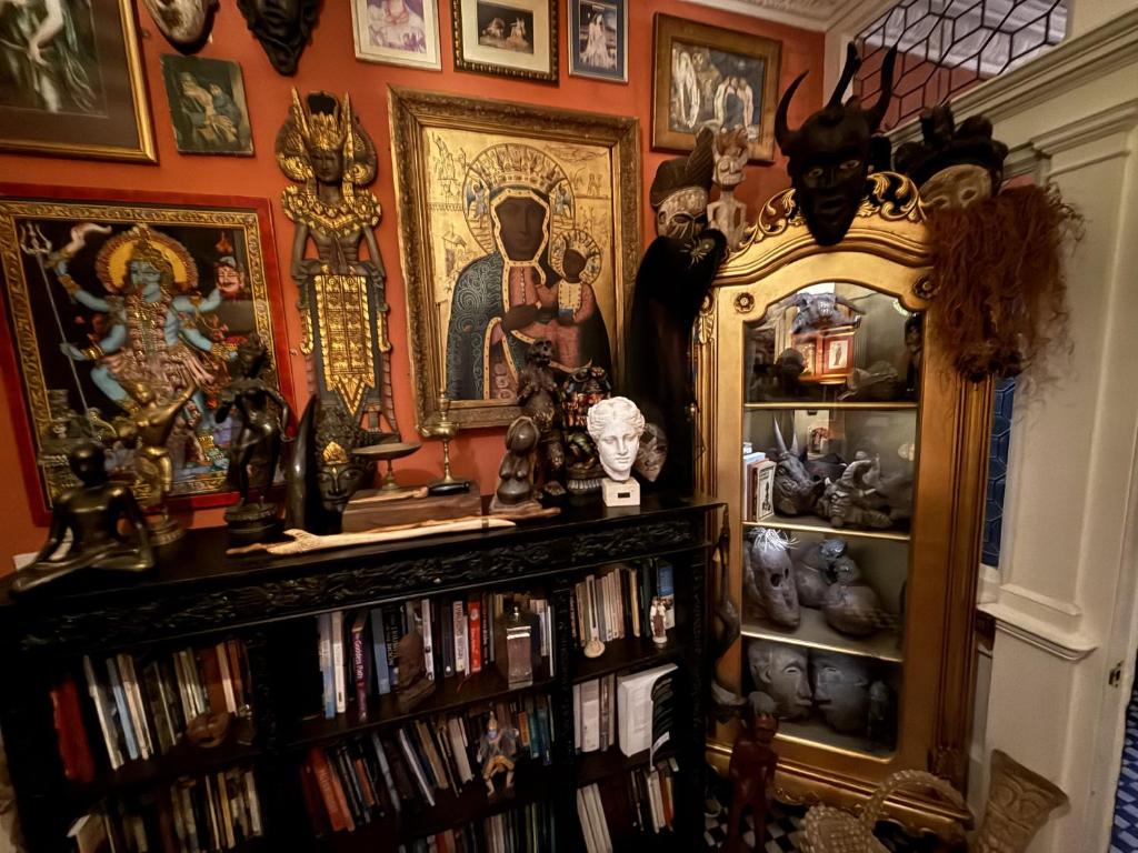 a room with a book shelf filled with books at The Covenstead in Glastonbury
