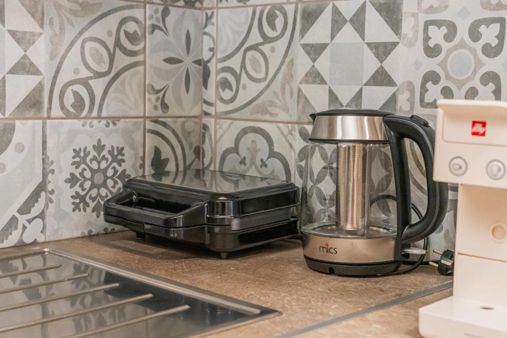 a kitchen counter with a toaster and a blender at Ioannina Center Apartment in Ioannina
