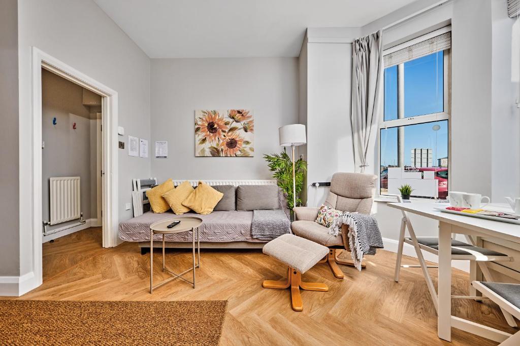 a living room with a couch and a table at Dunluce Park 1 - Dog friendly - Portrush by the Sea in Portrush