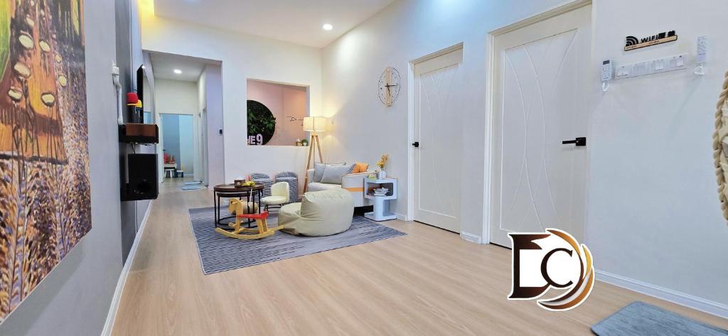 a living room with a couch and a chair at Skudai - The9 Homestay 1min UTM, near Sutera Mall, Paradigm Mall, Senai airport in Skudai