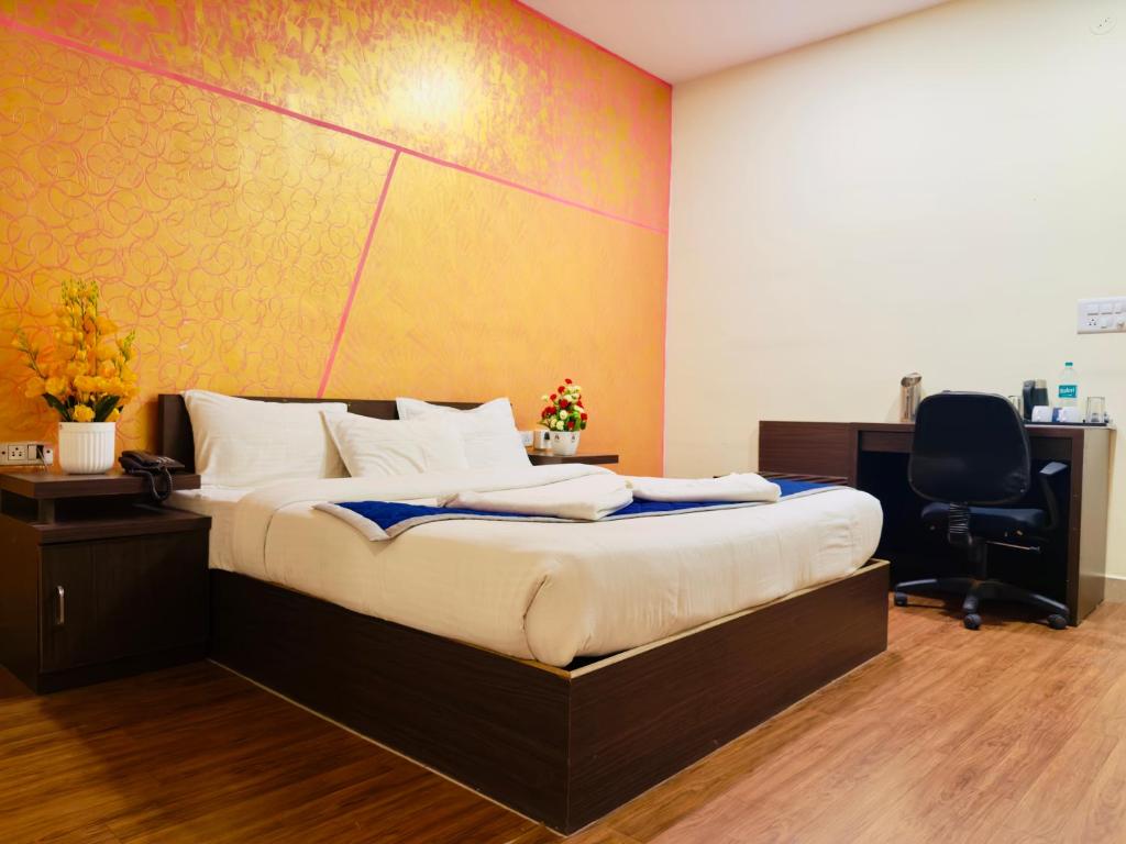 Postel nebo postele na pokoji v ubytování Hotel New Blue Rocks Sarjapur