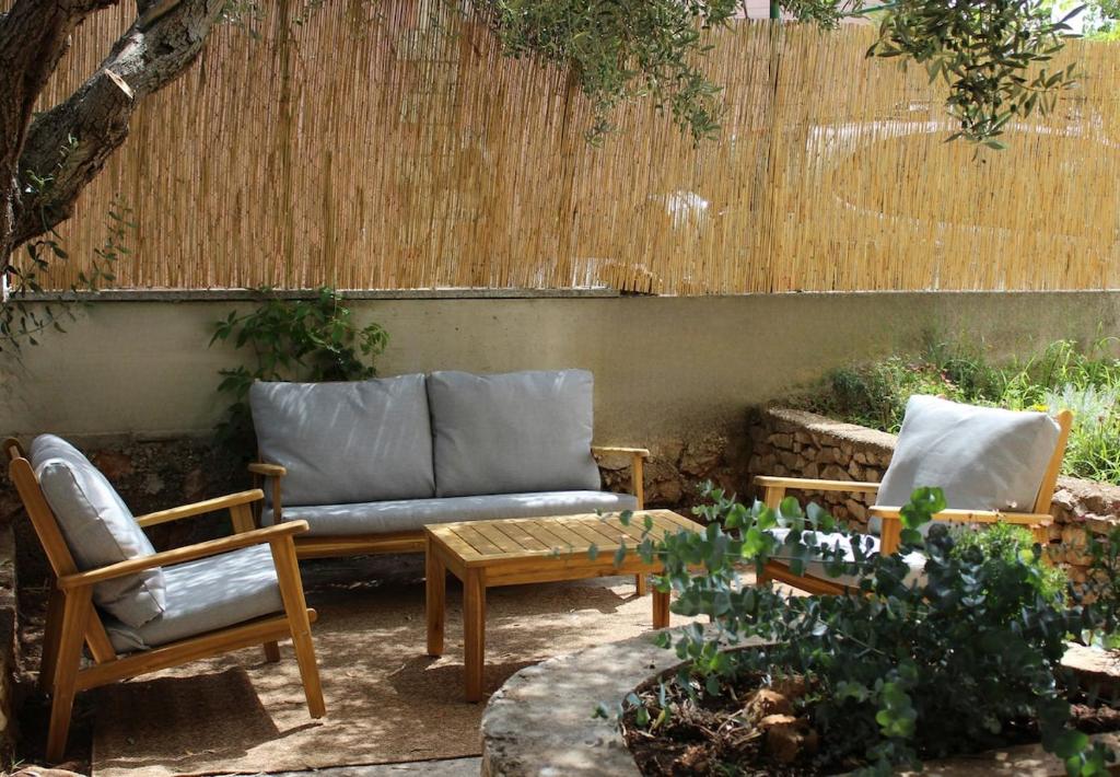 a patio with a couch and two chairs at Grandma's house in Rogoznica