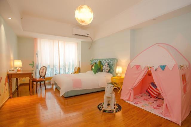 a bedroom with a bed with a tent in it at FRAGRANCE House Hanxi Changlong Panyu Wanda Plaza Store in Guangzhou