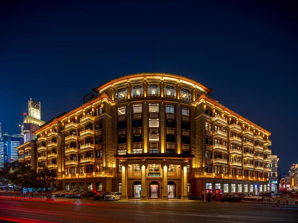 a large building is lit up at night at Xiamen Lujiang Harbourview Hotel-panoramic sea views over Gulangyu in Xiamen