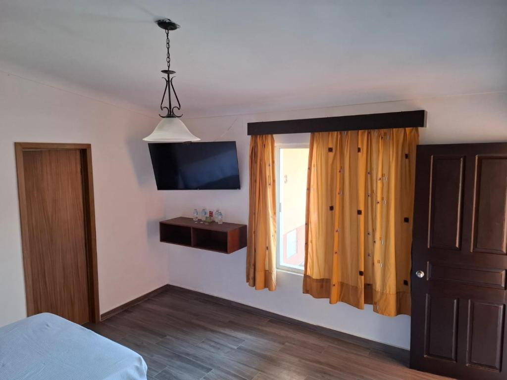 Postel nebo postele na pokoji v ubytování Hotel Aquiles
