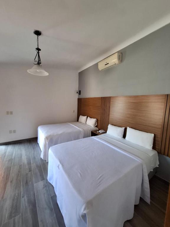 Postel nebo postele na pokoji v ubytování Hotel Aquiles