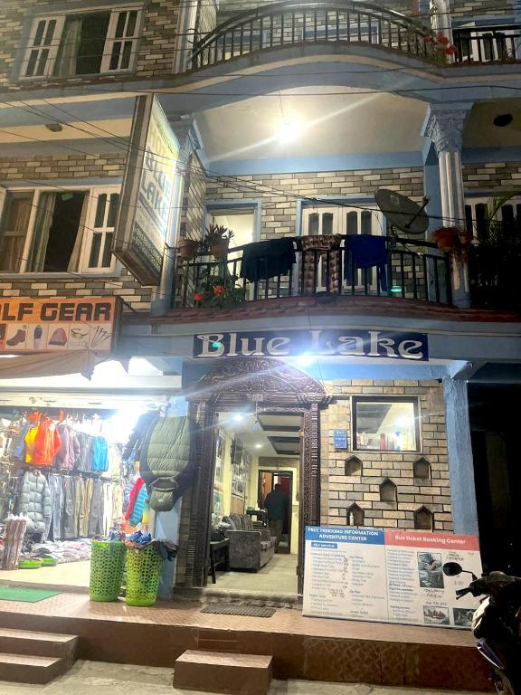 a building with a blue ceiling and a house at Hotel Blue lake in Pokhara