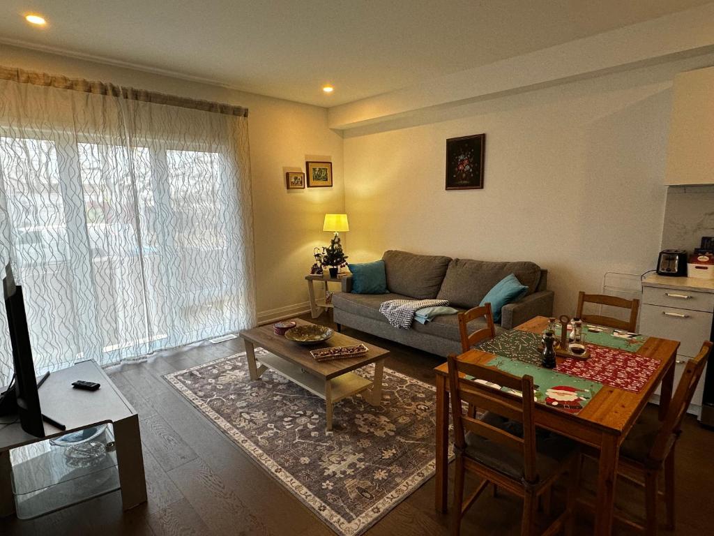 a living room with a couch and a table at Brand New 2 story unit in Richmond Hill
