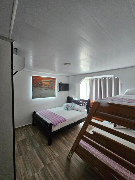 Postel nebo postele na pokoji v ubytování Hostal Shangiovys