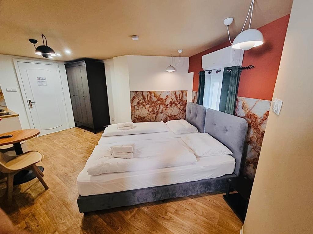 a bedroom with a large bed and a table at Modern Studio N9 Kitchenette Bathroom in Limassol