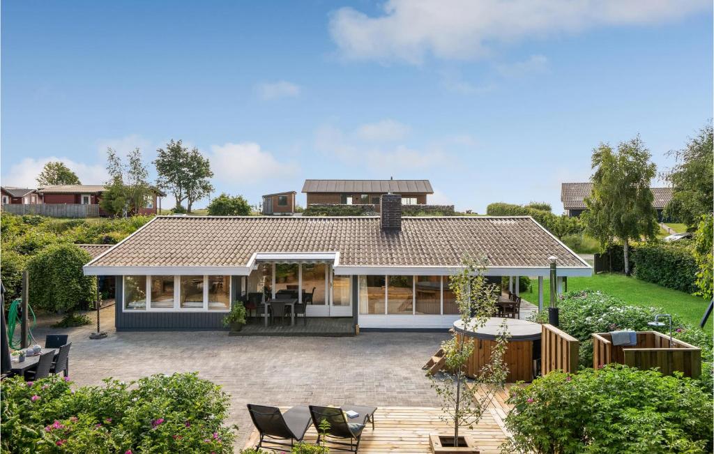 a house with a patio in front of it at Three-Bedroom Holiday Home In Ebeltoft in Ebeltoft
