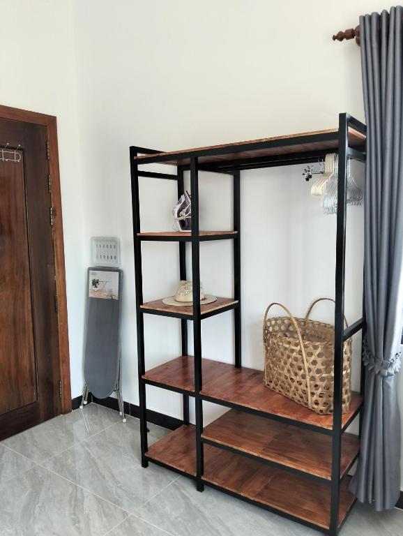 a black bunk bed with wooden shelves in a room at Baksaei Retreat Ricefield Villas in Kampot