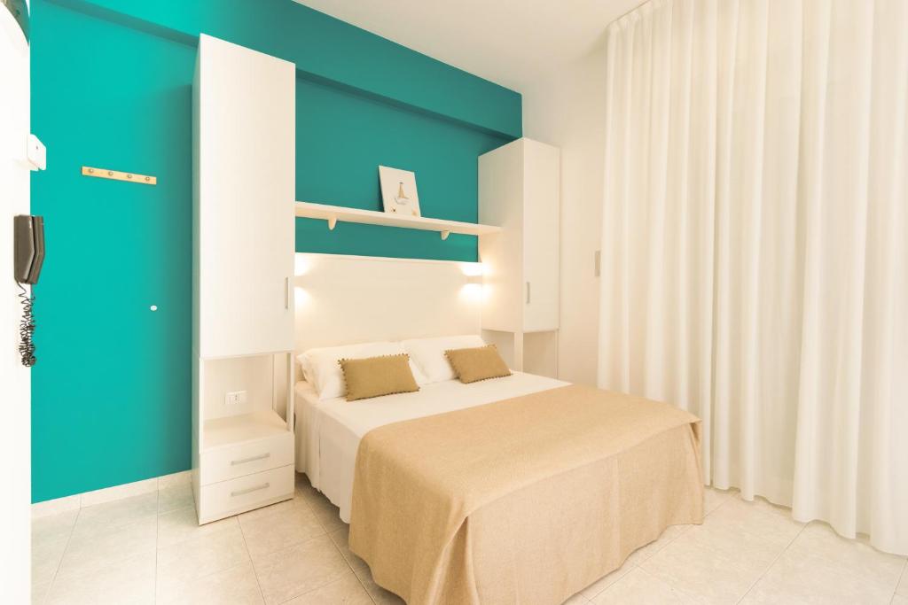 Postel nebo postele na pokoji v ubytování Ambra Hotel Cattolica