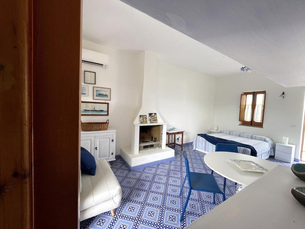 a living room with two beds and a fireplace at Casa a' Gnazia in Santa Marina Salina