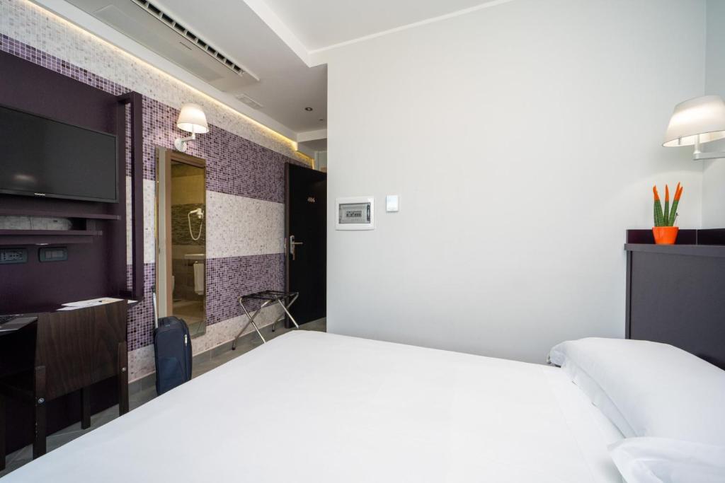 Postel nebo postele na pokoji v ubytování Hotel Majorana
