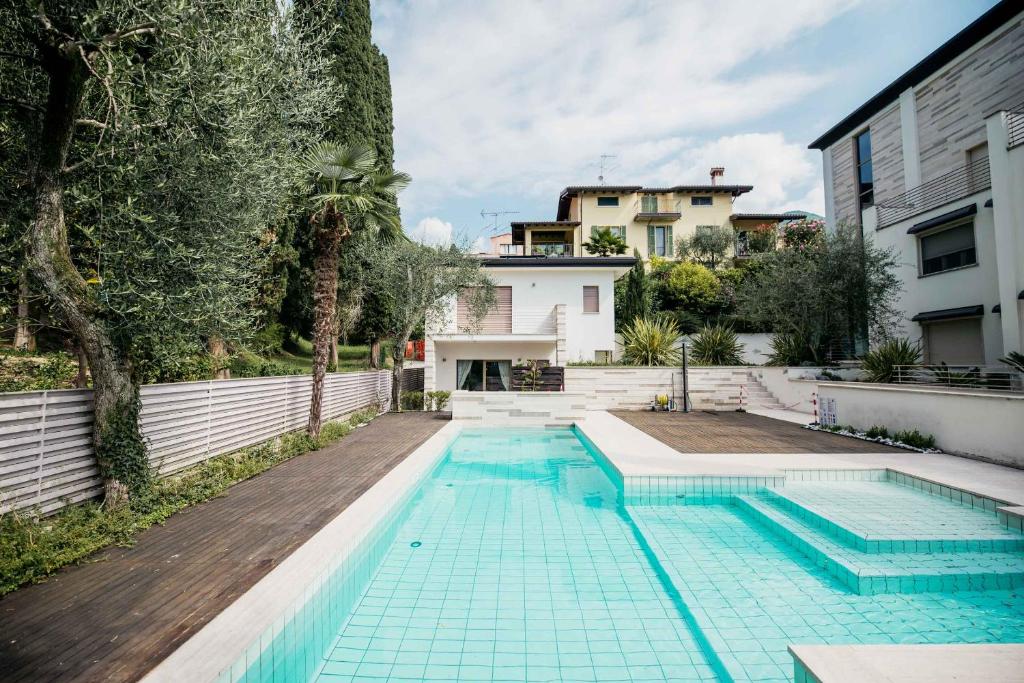 a swimming pool in the backyard of a house at Casa Chiara in Gardone Riviera