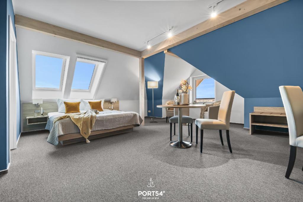 a bedroom with a bed and a table and chairs at Ferienwohnung Bude 2 Dagebüll in Dagebüll