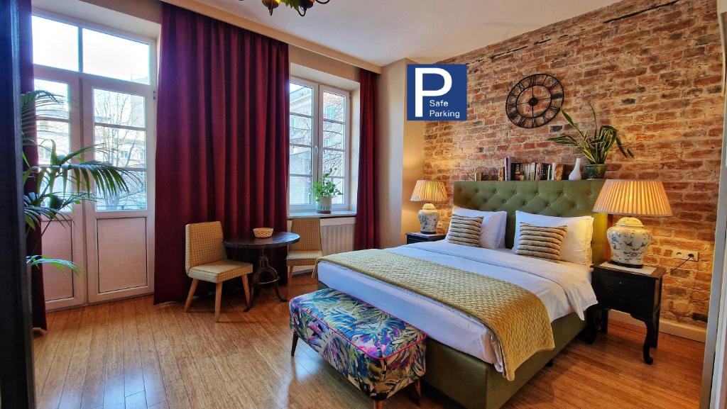 a bedroom with a bed and a brick wall at SLEEPWELL NOWY ŚWIAT - wejście przez dziedziniec - brama Ordynacka 14 in Warsaw