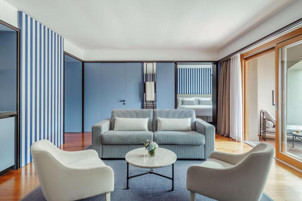 a living room with a couch and chairs and a table at Tivoli Portopiccolo Sistiana Wellness Resort & Spa in Sistiana