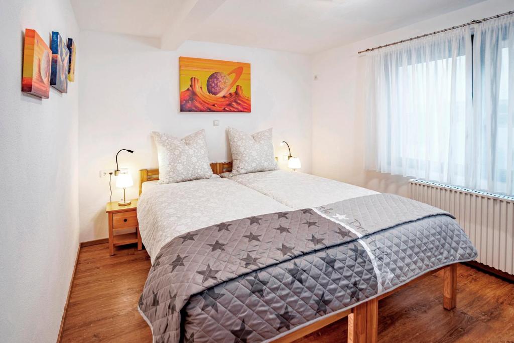 a bedroom with a large bed and a window at Ferienhaus Sternschnuppe in Oberwesel