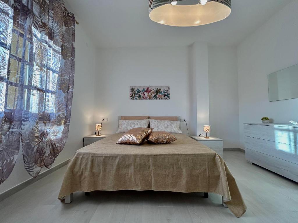 a bedroom with a bed with two pillows on it at Residenza Serra in Villasimius