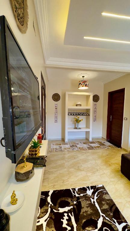 a living room with a large flat screen tv at Horus pyramids view in Cairo