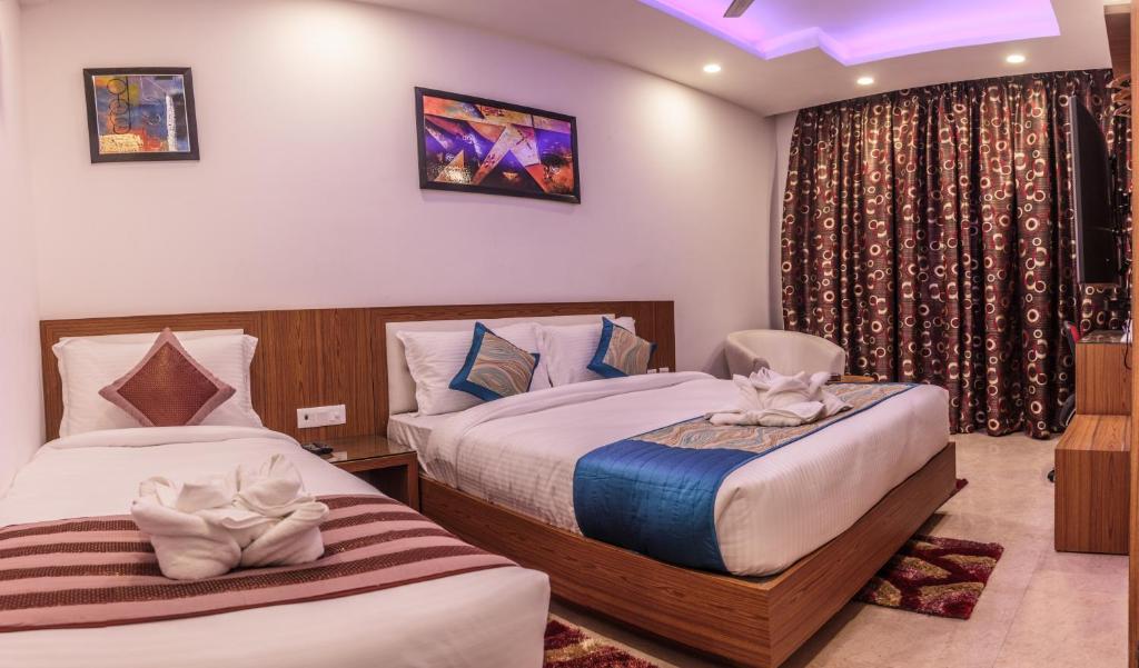 Postel nebo postele na pokoji v ubytování Hotel Suktara International